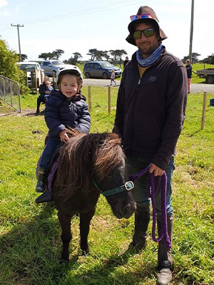 Mike Hovard with son Harry at pony club